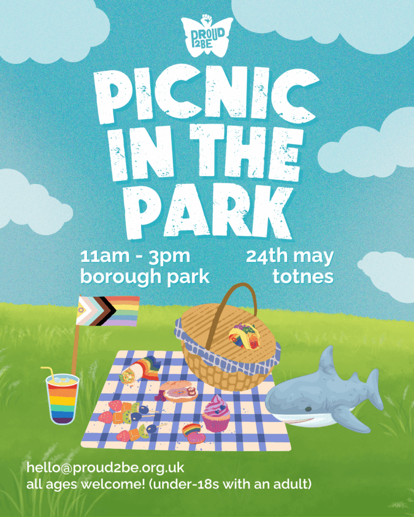 A blue sky with pale white clouds, above a grassy field. At the top centre is the Proud2Be butterfly logo, followed by bold white text reading: PICNIC IN THE PARK. The details of time, location, and age limits are stated below, as given in the caption. On the grass is a progress pride flage, next to a picnic basket on a blue and cream check patterned picnic blanket, with various pride flag coloured foods; fruit, a bi cupcake, lesbian bagel, and rainbow cookies, fajita wrap, taco, and drink. Also on the picnic blanket is the trans icon, Blåhaj (a stuffed toy shark). In the lower left corner is the email address hello@proud2be.org.uk